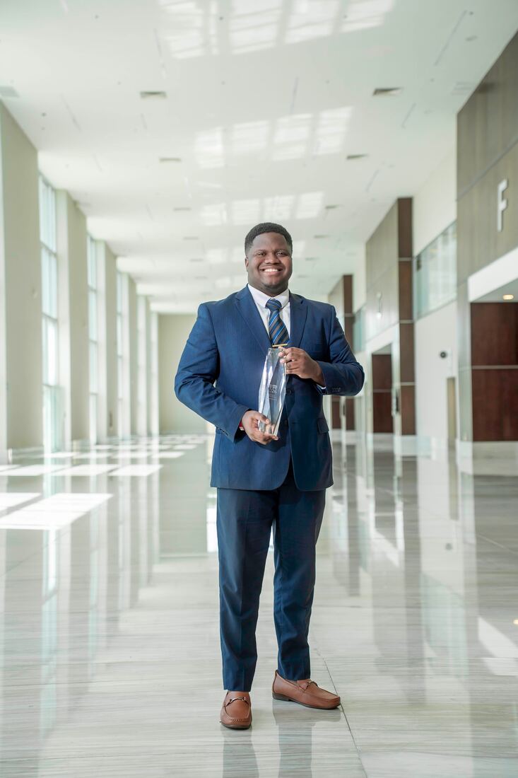 Next Gen Exposure Inc leadership holding a company achievement award