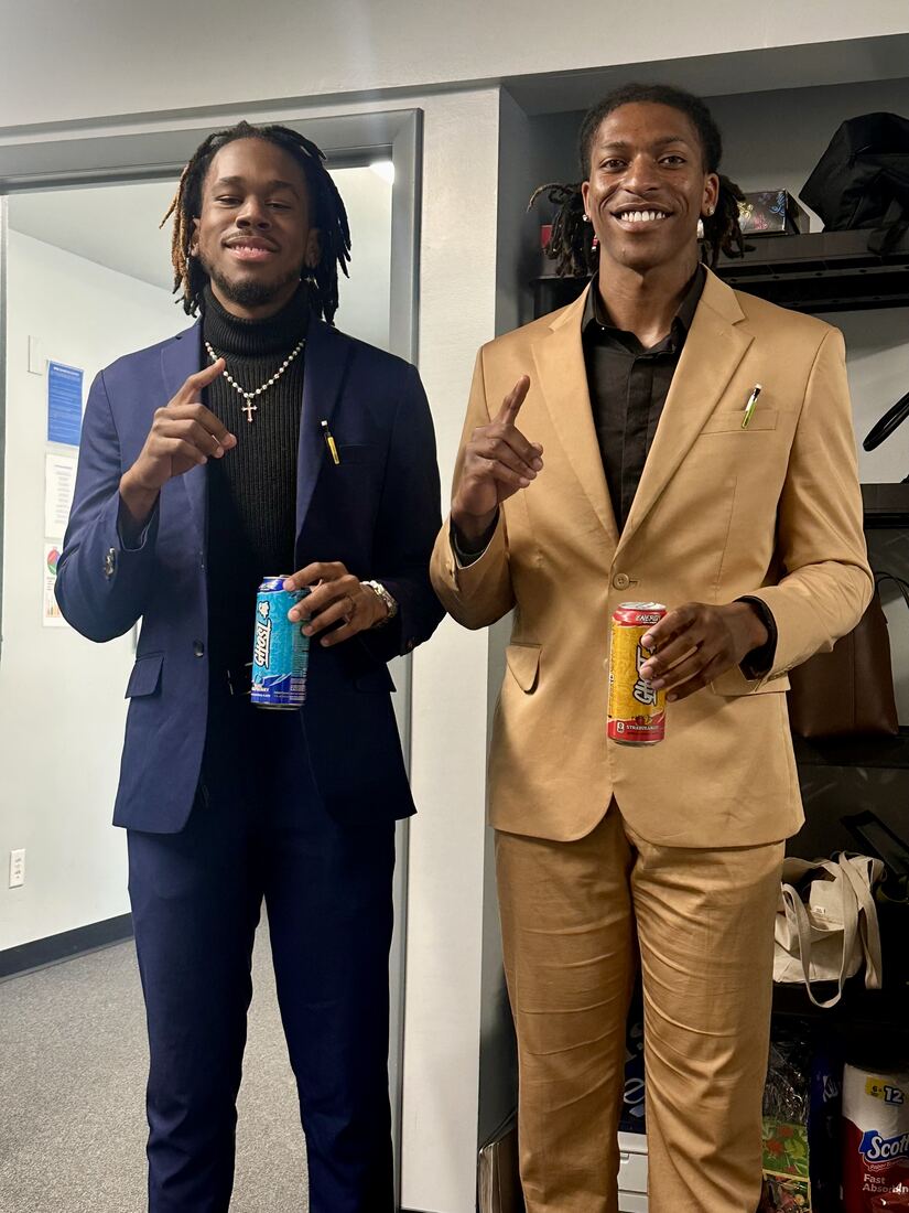 Two Next Gen Exposure Inc in-store support specialists in business attire