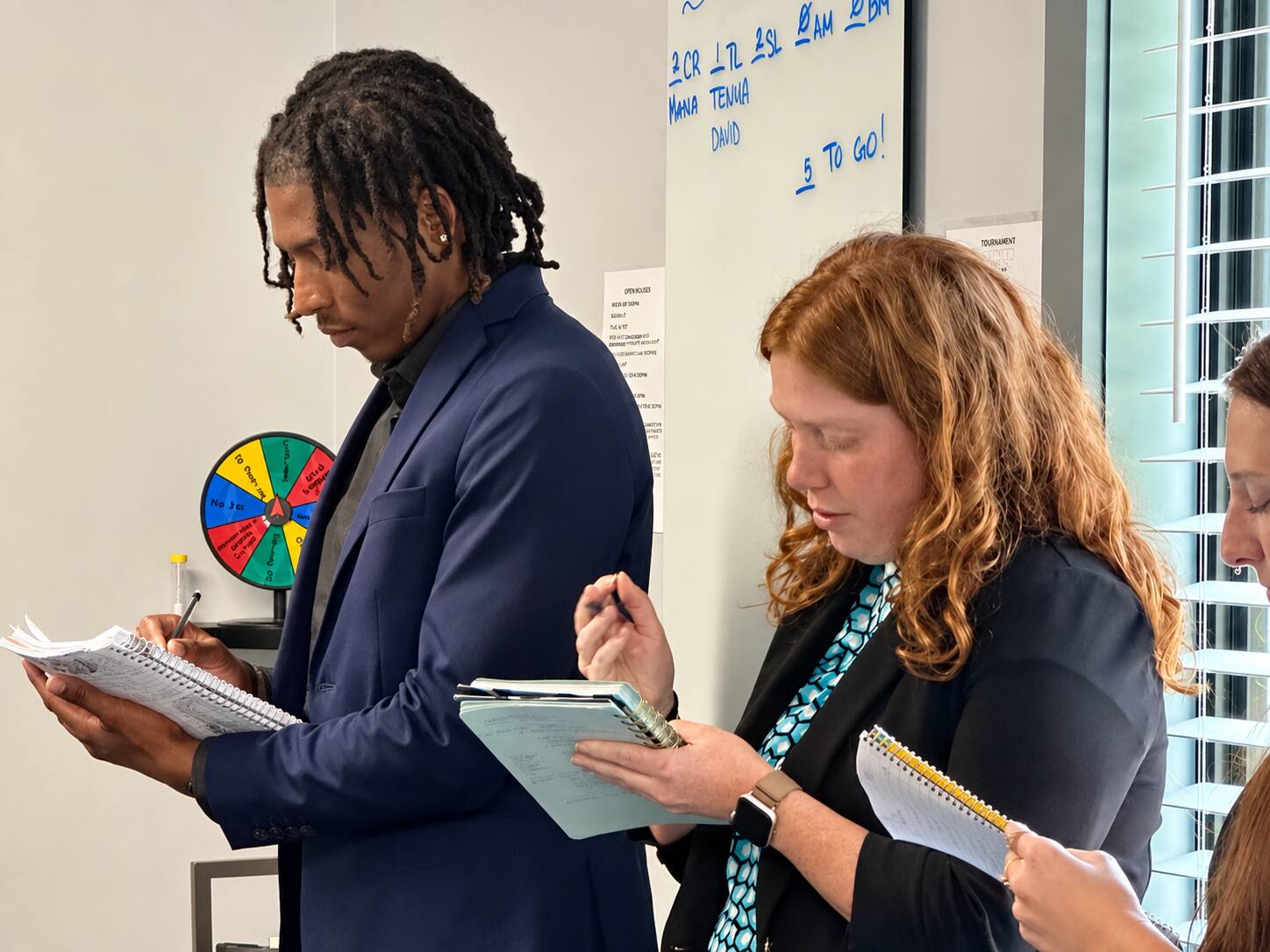 Next Gen Exposure Inc team members taking notes during a training session